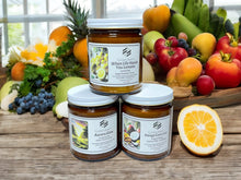 Load image into Gallery viewer, Hand Poured candles in amber jars full of fresh citrus and juicy fruits.
