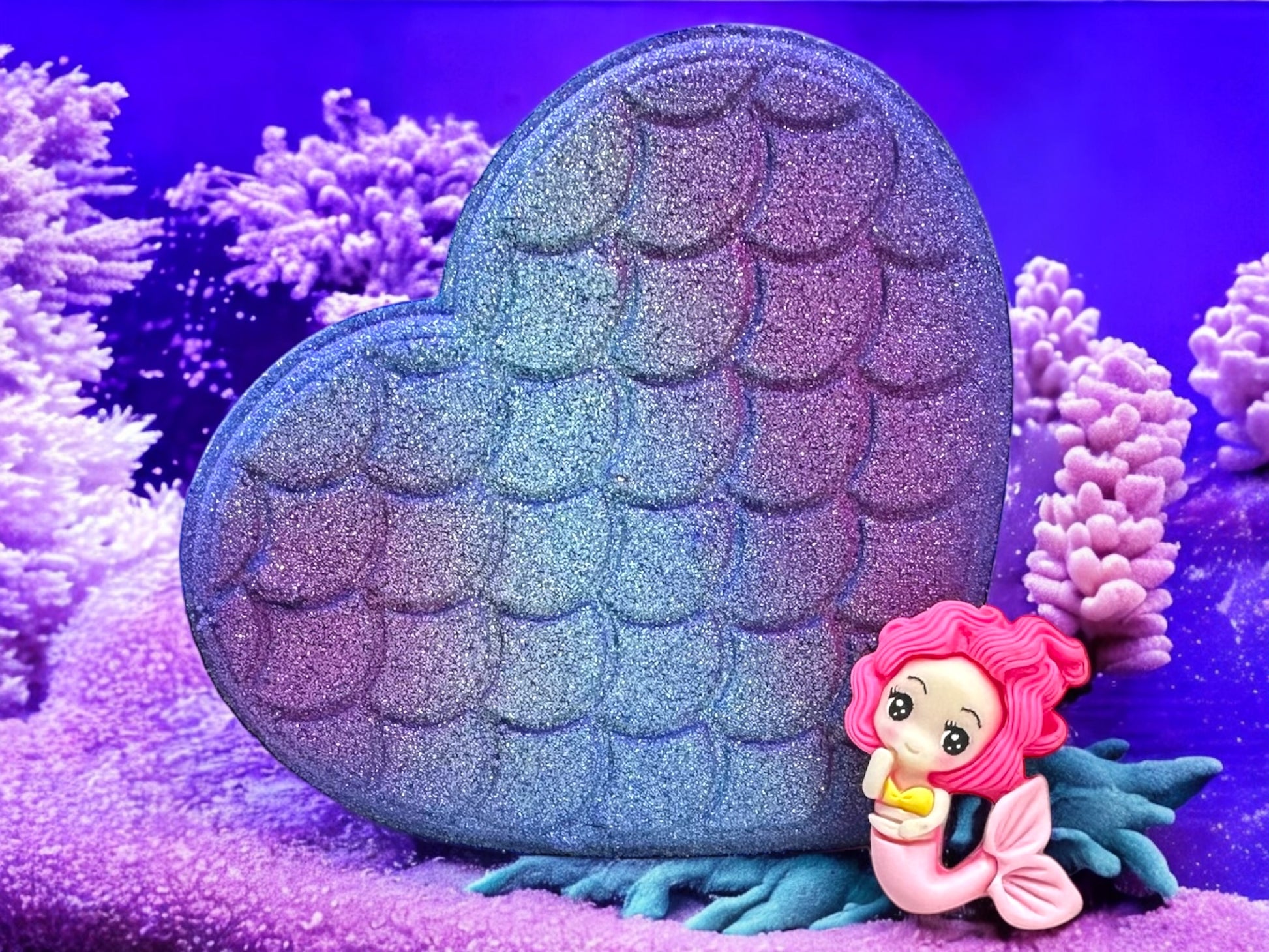 Make a splash with our Mermaid Heart Bath Bomb!
This heart-shaped bath bomb fizzes into a stunning shade of purple and fills your tub with the fresh, fruity fragrance of juicy tangerine, spring water, and soft musk